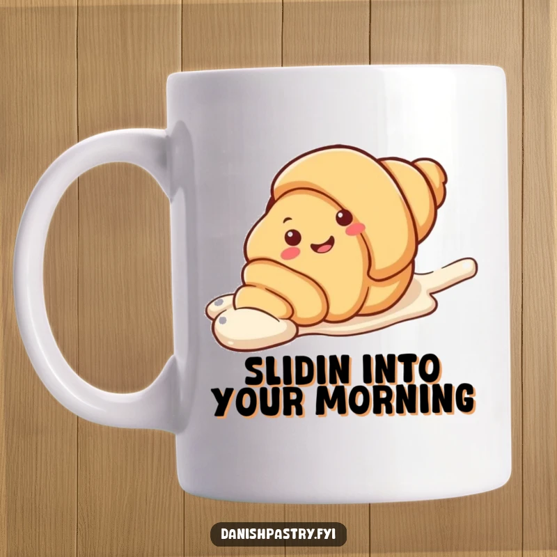 Funny Mug showing a smiling croissant character playfully sliding down a sugary icing streak. A delicious design for pastry lovers.