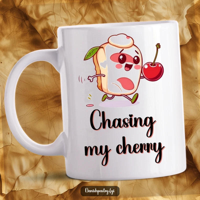 Funny Danish pastry mug, character comically chasing a rolling cherry, a whimsical and amusing gift.