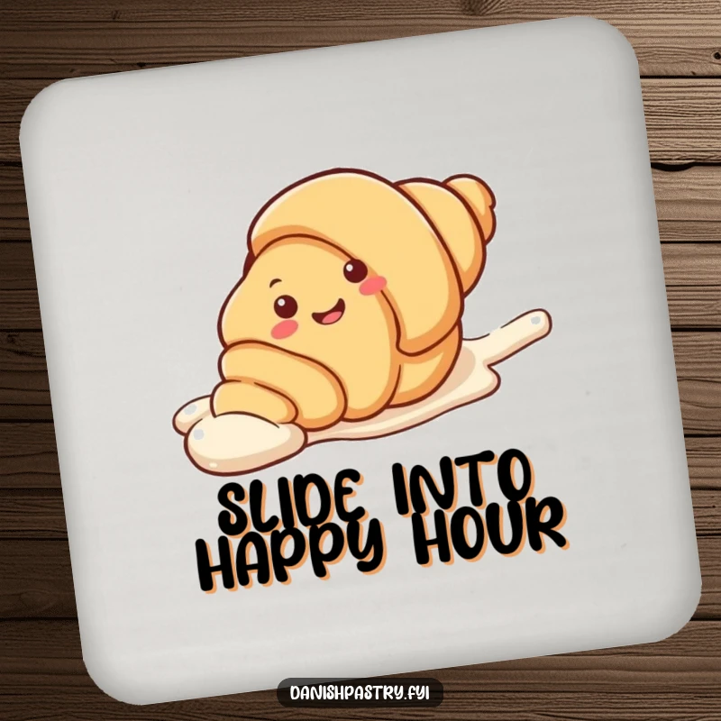 Funny Drink Coaster showing a smiling croissant character playfully sliding down a streak of icing. A sweet and humorous accessory.