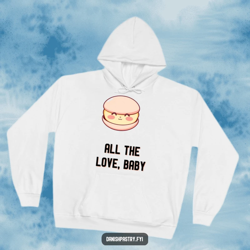 Funny hoodie featuring a happy macaron with rosy cheeks, blowing a sweet kiss, a cozy and charming design.
