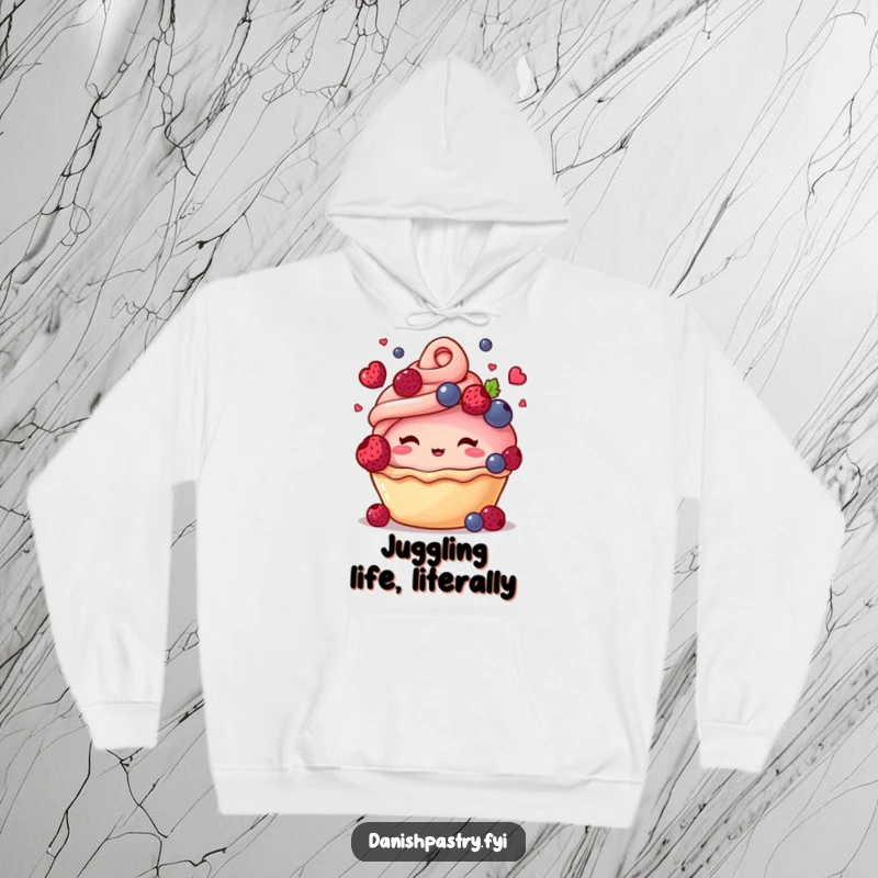 Funny hoodie depicting a blushing pastry character with a swirl top, playfully juggling small berries, radiating warmth and joy.