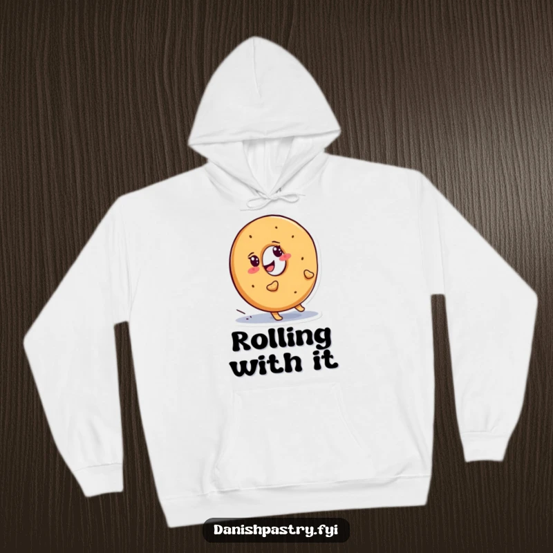 Funny bagel hoodie featuring a smiling character determinedly waddling uphill, a symbol of perseverance and warmth.