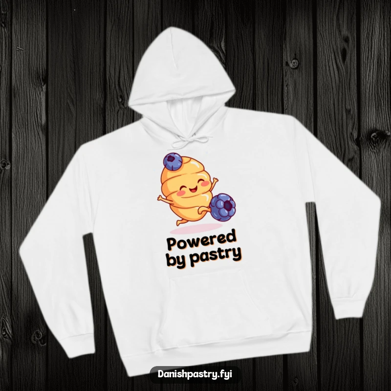 Funny Hoodie: A smiling croissant with tiny legs kicks a blueberry with glee, perfect for cozy, humorous lounging.