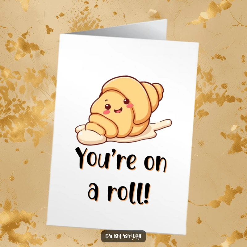 Funny Free Printable Congratulations Card featuring a cheerful croissant character playfully sliding down a sweet streak of icing.