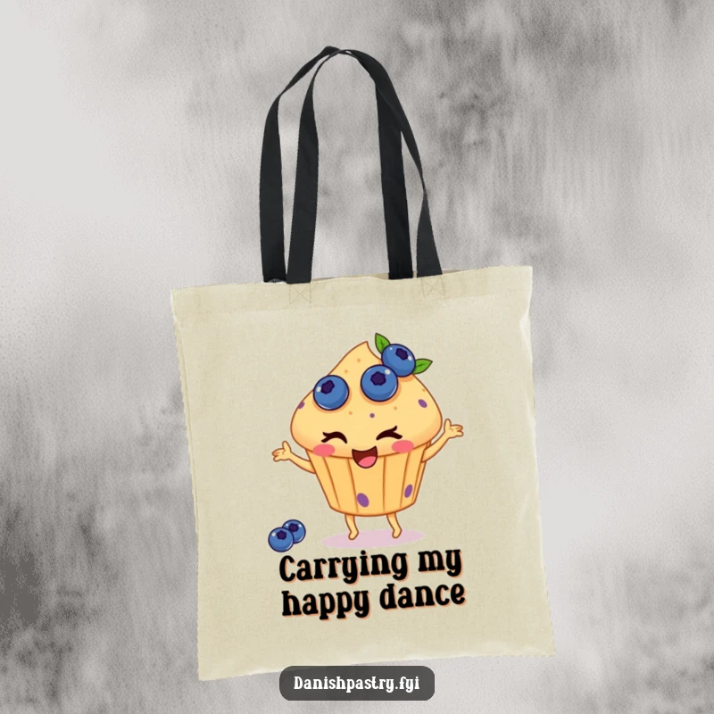 Funny tote bag featuring a winking muffin with blueberries, happily dancing, perfect for carrying essentials with a dose of charming, sweet humor.